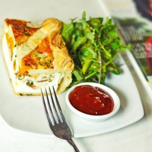 Bacon and egg pie with salad greens